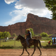 A man riding a horse through Supai Village, Arizona. Photo Courtesy Sarana Riggs